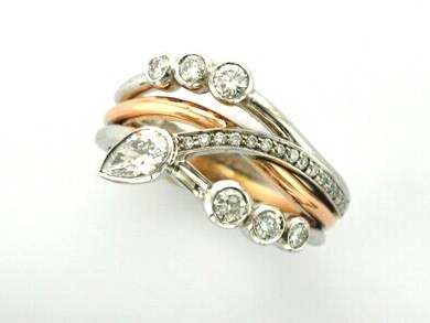 Amie is a Bespoke Diamond Ring designed as a Three Wave Signature Brook Wave Ring with Pear Shape & Brilliant Cut Diamonds with Pave set Diamonds to add extra sparkle.