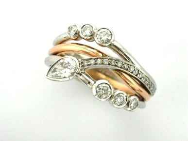 Amie is a Bespoke Diamond Ring designed as a Three Wave Signature Brook Wave Ring with Pear Shape & Brilliant Cut Diamonds with Pave set Diamonds to add extra sparkle.