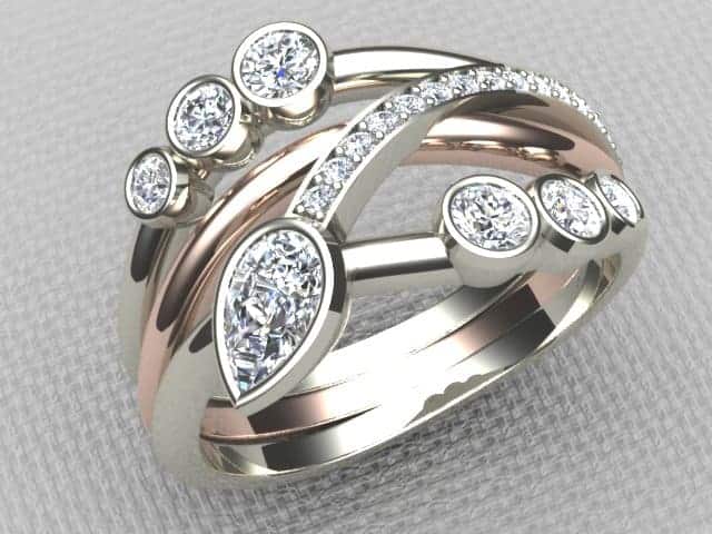 Amie is a Bespoke Diamond Ring designed as a Three Wave Signature Brook Wave Ring with Pear Shape & Brilliant Cut Diamonds with Pave set Diamonds to add extra sparkle.