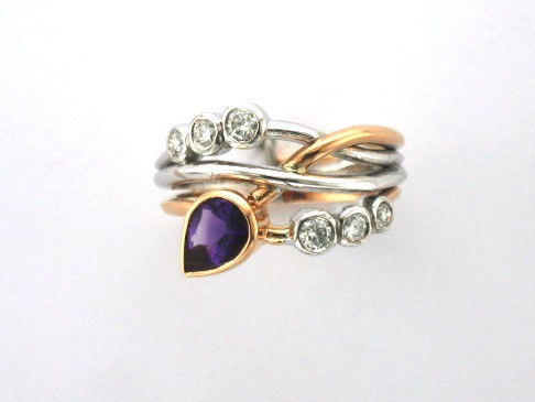 Signature Brook Wave Ring Designed with Pear Shape Amethyst & Tapering Brilliant Cut Diamonds as a triple wave, Right Hand Ring. Zoe Bespoke Diamond Ring was custom made in 18ct Rose & White Gold to celebrate February birthdays for two little girls.