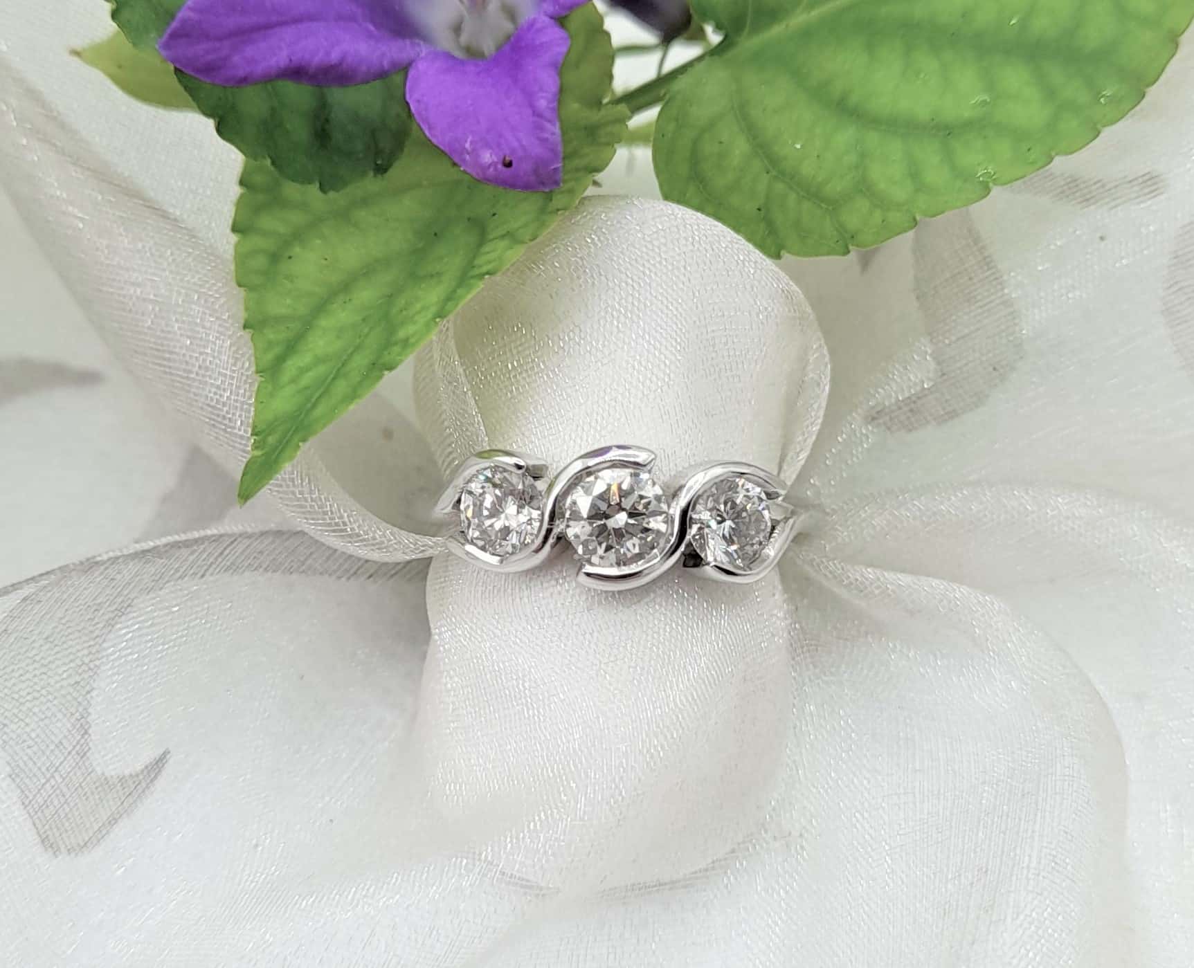 Elegant Bespoke Diamond Ring re-modelled in 18ct Gold with open curved bezels to refresh client's much loved Engagement Ring by Pearl Perfect Design Room.
